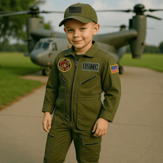 Youth in USMC Marines flight suit combo with embroidered patches, standing near military vehicle on a sunny day.