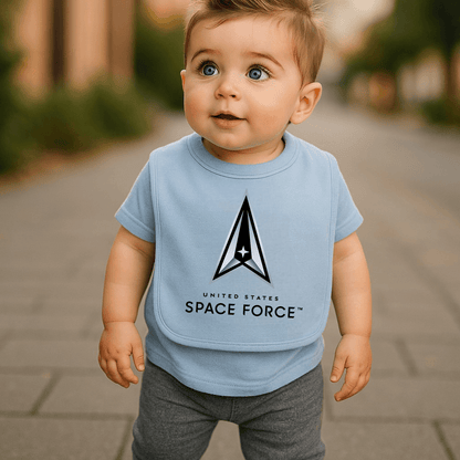 A happy baby wearing the Space Force Boys Baby Bib by Trooper Clothing while standing on a pathway.