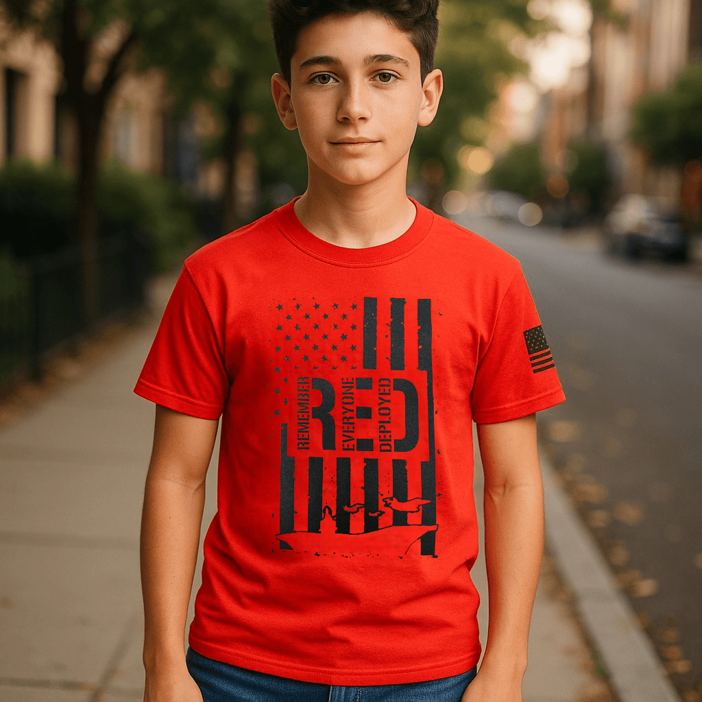 Patriotic youth t-shirt featuring Remember Everyone Deployed logo and American flag design on a red tee.