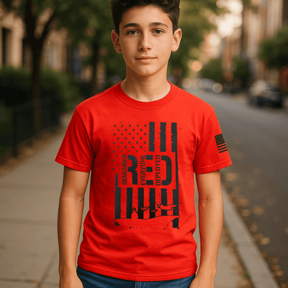 Patriotic youth t-shirt featuring Remember Everyone Deployed logo and American flag design on a red tee.
