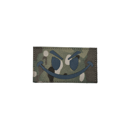 Camo smiley patch featuring a playful design on a green camouflage background.
