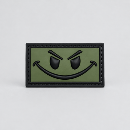 Patch OD Green and Black Smiley PVC with hook-and-loop backing, perfect for enhancing your gear.