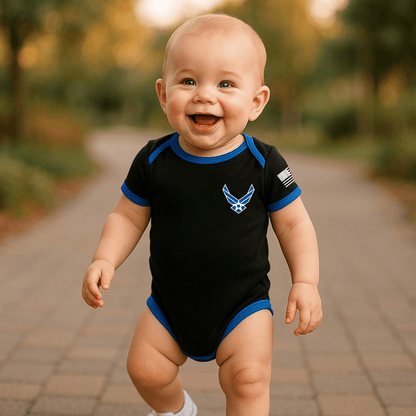 Baby wearing a Trooper Licensed Air Force bodysuit with blue trim and smiling outdoors.