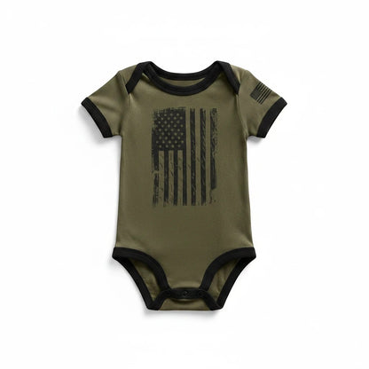 Trooper Clothing OD green baby bodysuit with distressed American flag print and black trim details.