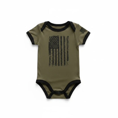 Trooper Clothing OD green baby bodysuit with a distressed American flag print and black trim details.