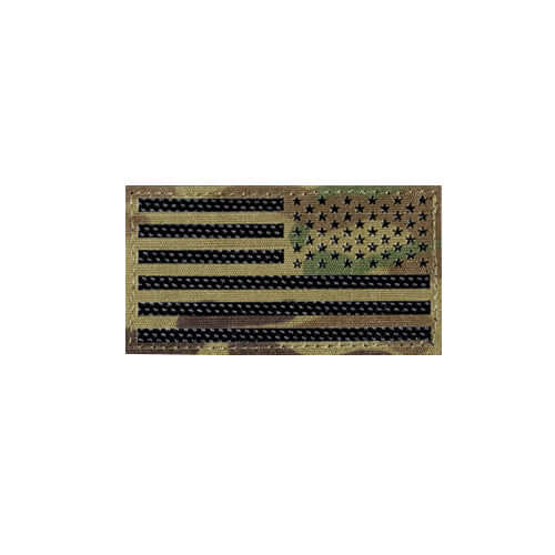 Black and green American flag patch on camouflage background for tactical clothing and gear.