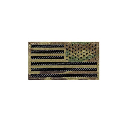 Black and green American flag patch on camouflage background for tactical clothing and gear.